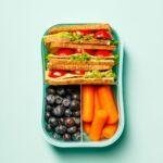 packed lunchbox with sandwiches, carrots and blueberries
