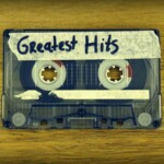 Cassette tape with masking tape label and hand written 'Greatest Hits'
